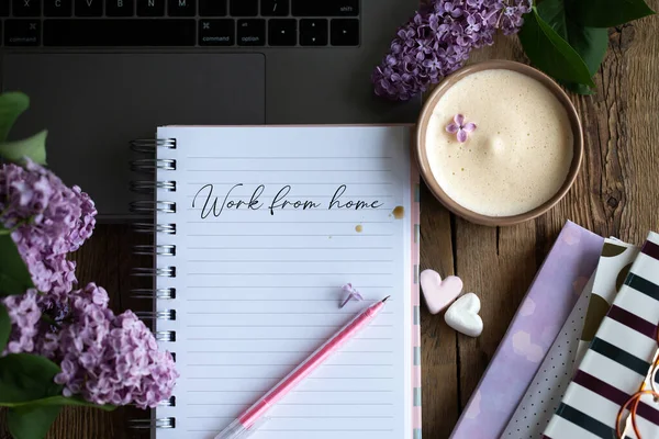Work from home.The call to stay home during the coronavirus.Writing in a notebook with a cup of coffee and a bouquet of deer.Concept of romance with a cup of coffee.A cup of coffee with lilacs.Latte