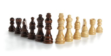 Wooden chess pieces on white background clipart