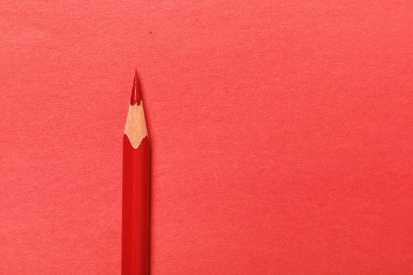 Red pencils lies on a red background — Stock Photo, Image