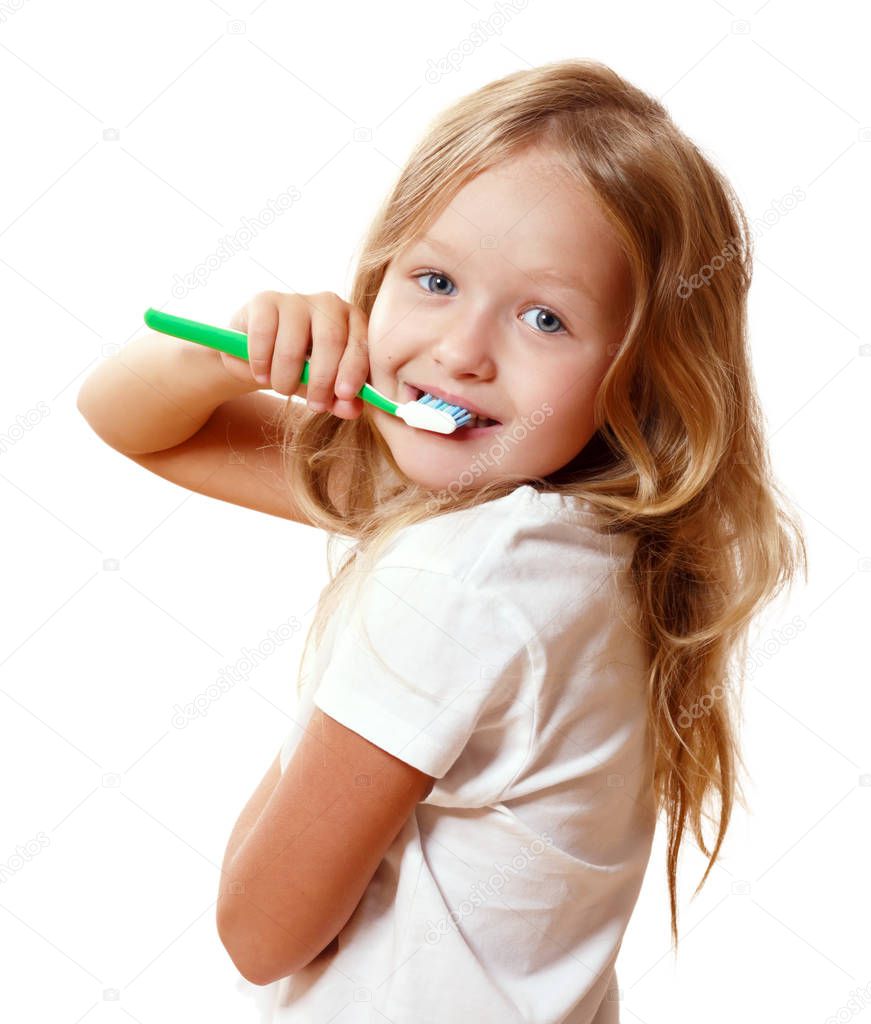 A little kid girl is brushing her teeth with a toothbrush. The c