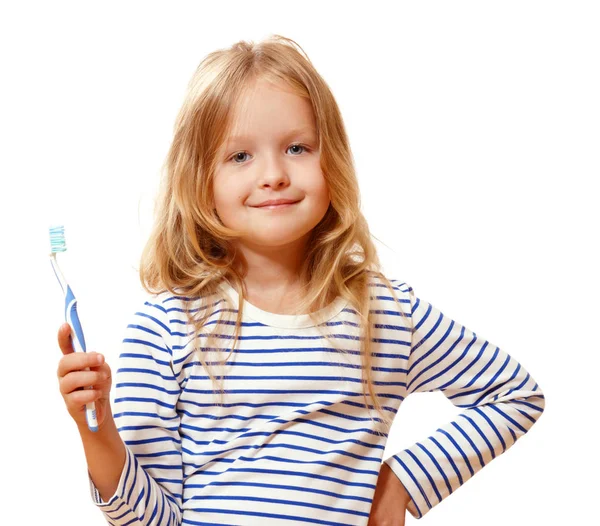 Holčička v pruhovaném pyžamu si čistí zuby od... — Stock fotografie