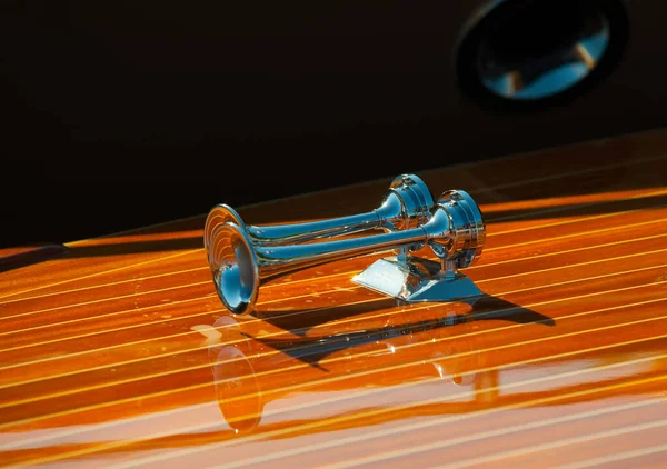 Delicate details of a hand made wooden boat. Polished metal horns.