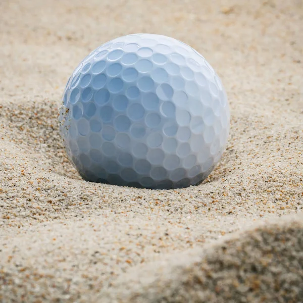 Feche a bola de golfe no bunker de areia profundidade rasa de campo. Um golfe — Fotografia de Stock