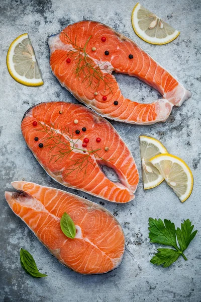 Fresh salmon fillet sliced flat lay on shabby metal background.