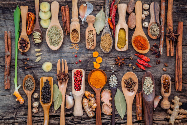 Various of spices and herbs in wooden spoons. Flat lay of spices
