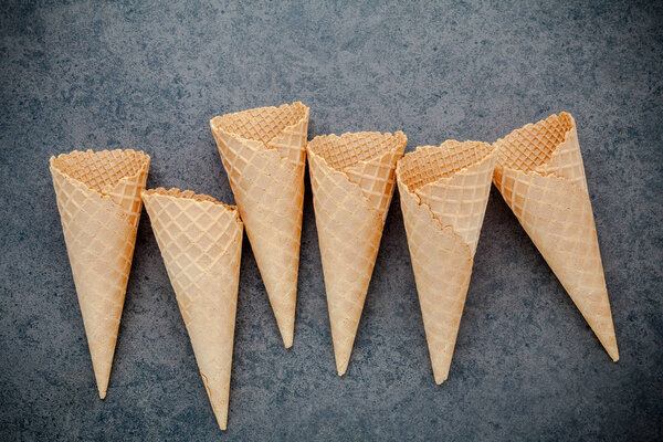 Flat lay ice cream cones collection on dark stone background . B