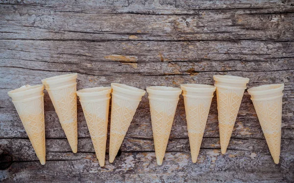 Flat lay ice cream cones collection on shabby wooden background — Stock Photo, Image