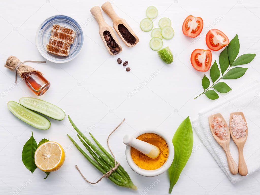 Natural herbal skin care products. Top view ingredients cucumber ,aloe vera ,lemon ,honey ,himalayan salt and tomato on table concept natural face moisturizer. Facial treatment preparation background.
