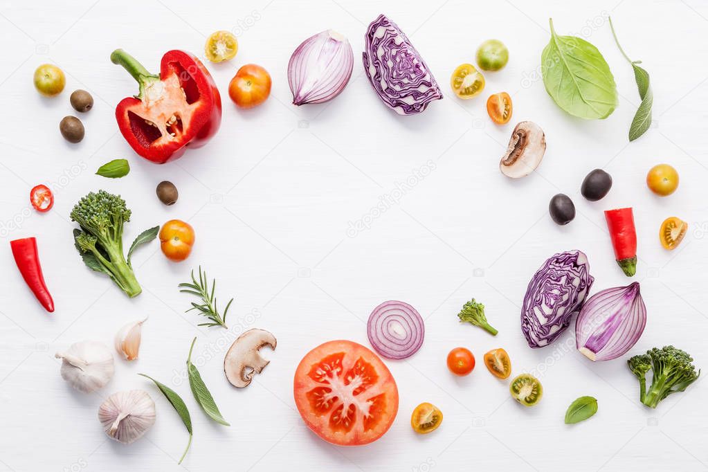 Various fresh vegetables and herbs on white background.Ingredients for cooking concept sweet basil ,tomato ,garlic ,pepper and onion with flat lay.