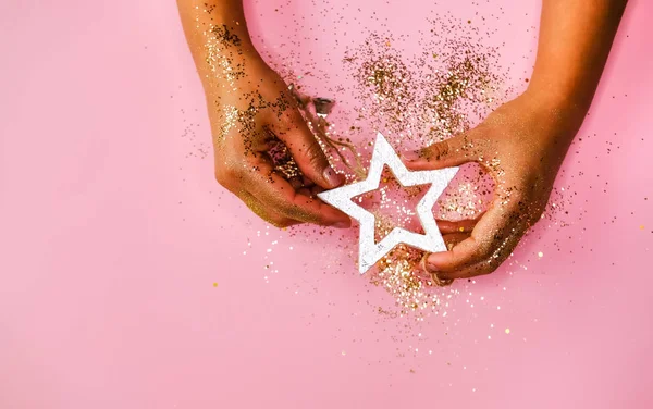Hands and golden star.