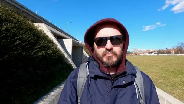 ジャケットとサングラスでクールな髭の男は 市内の階段を歩いて アクションカメラ 広角ビュー コンセプトに影響を与えるソーシャルメディアでVlogging — ストック動画