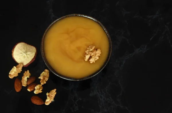 honey and nuts on a black background