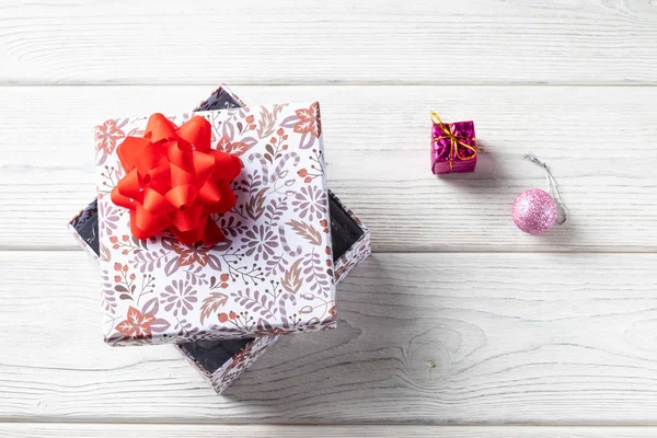 Caja de regalo navideña sobre un fondo de madera blanco. con decoraciones navideñas —  Fotos de Stock