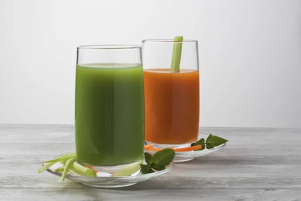 Fresh vegetables smoothie carrots, celery and greens with mint. On a light background — Stock Photo, Image