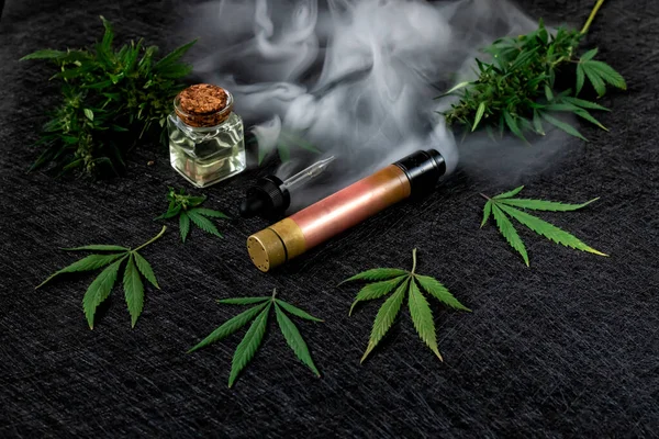 Líquido de cannabis. Vape CBD o THC, Vaping Marihuana y Cáñamo. Contra un fondo oscuro. Vapor grueso . —  Fotos de Stock