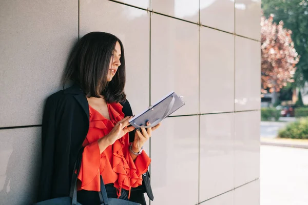 Picture of woman leaning back against a wall