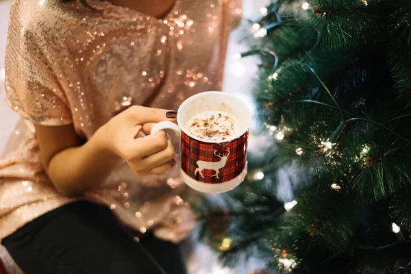 Close-up view of woman holding cup with cappuccino