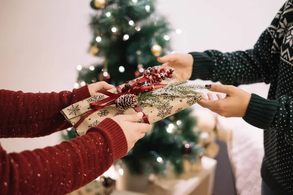 Child giving Christmas present to his mother