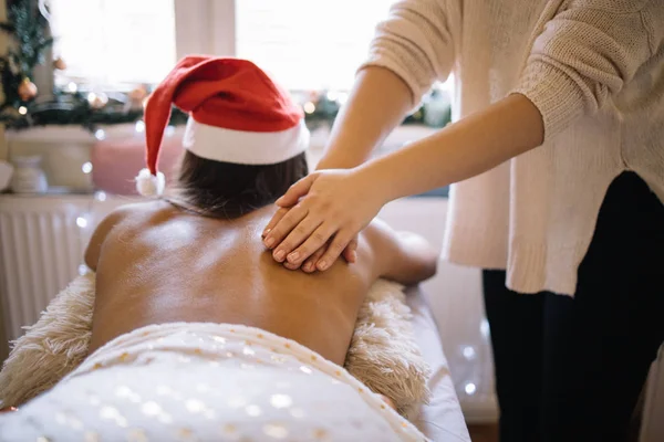 Massaggiatrice massaggiatrice nel salone decorato di Natale — Foto Stock