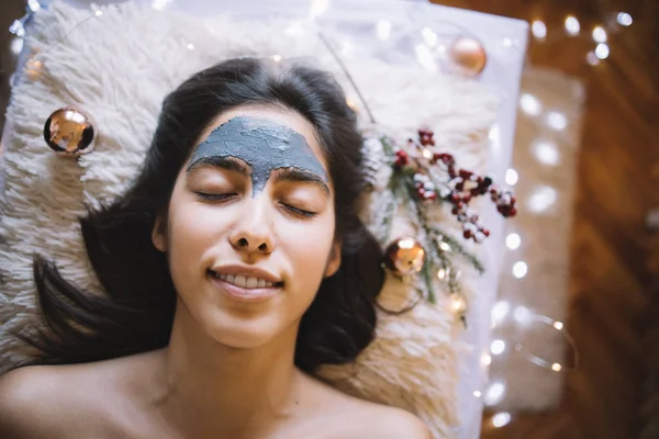 Young girl with mask on forehead relaxing at SPA — Stock Photo, Image