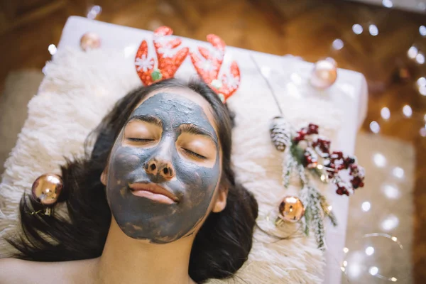 Young girl with face mask and Christmas headband — Stock Photo, Image