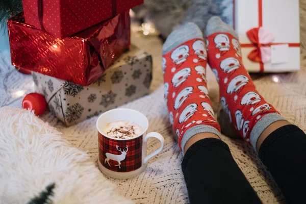 Close-up of female legs with Santa socks — Stock Photo, Image