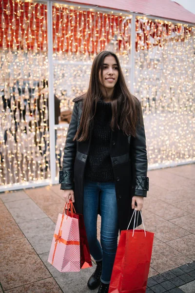 Ung kvinna med väskor shopping för jul — Stockfoto