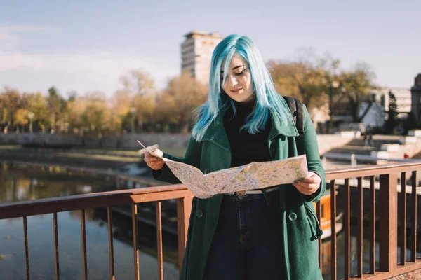 Young woman searching for direction on map