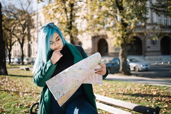 Travel girl wondering where she is and holding a map