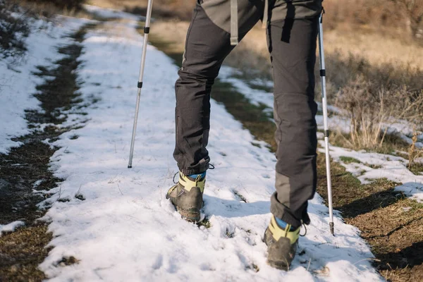 Close-up of male hiker legs on snow road — 스톡 사진