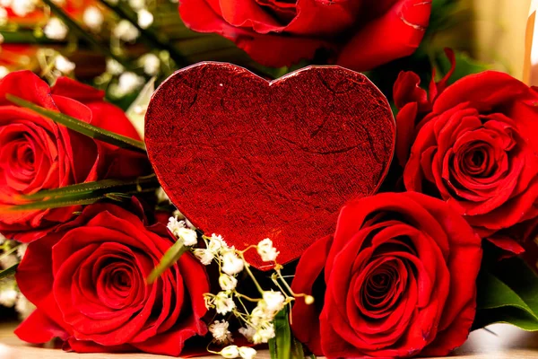 Red roses and gypsophila with heart shaped chocolate — Stock Photo, Image