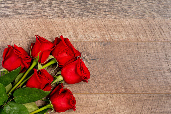Красные розы на деревянном фоне
