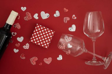 Kırmızı şarap şişesi ve gözlüklü sevgililer günü hediyesi.