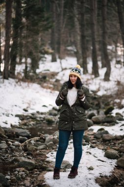 Woman posing and looking at camera in park