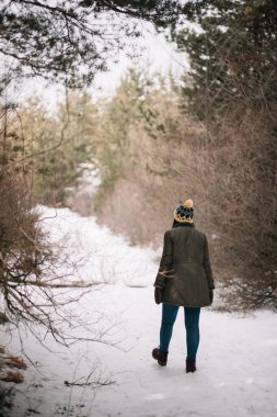 Explorer woman walking alone on snowy road