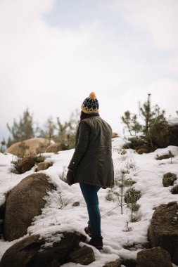 Girl standing on a mount with snow