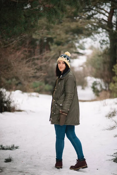 Girl on snowy road in the forest — 스톡 사진