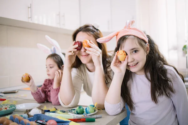 Woman with decorated Easter eggs over eyes — ストック写真