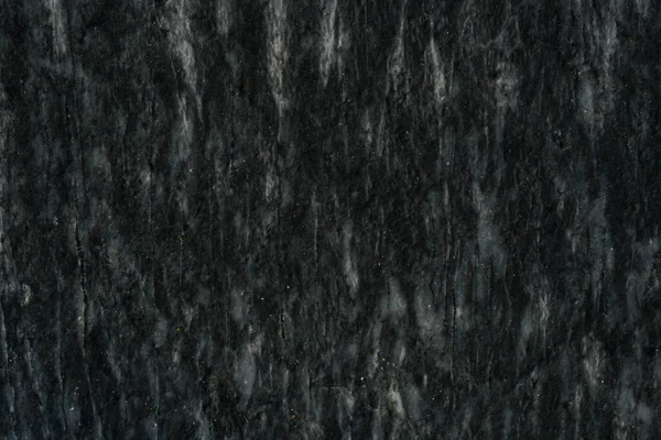 Чорний кам'яний візерунок з білими частинами і тріщинами — стокове фото