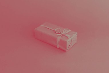 Fiyonklu altın kutu. Renkli pembe arka planda bir hediye. Her amaç için harika bir tasarım. Moda, cazibe arka planı. Yeni yıl, Noel tasarımı.