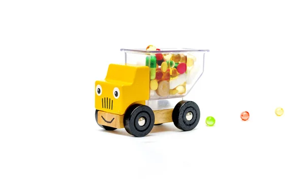 Truck car toy delivers vitamins pills medications for baby child on a white isolated background. — Stock Photo, Image