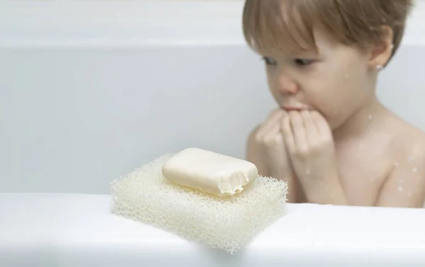 Bar soap with tooth marks closeup. small child boy bit off bar of soap and bit his mouth. Humor concept favor iquid soap with dispenser and proper hygiene disinfection. Baby unattended in bathroom