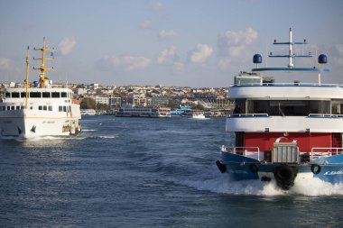 Two steamer at sea. The small passenger ferry in front and the large traditional Istanbul ferry in the arc.