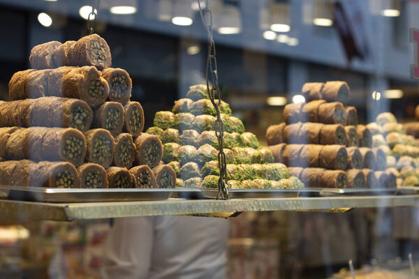 Traditional fresh baklava with pistachio nuts, pyramid shop display.