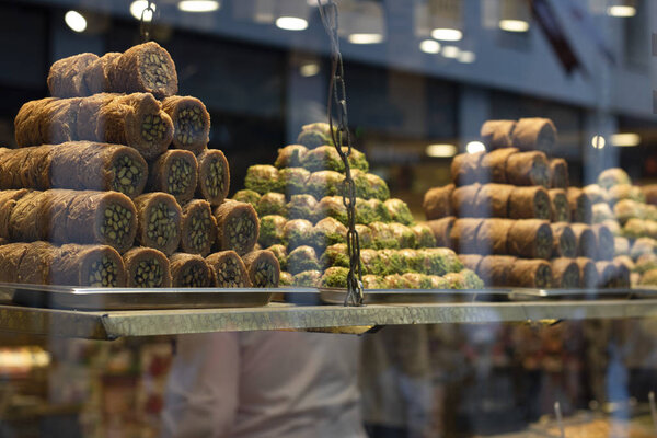 Traditional fresh baklava with pistachio nuts, pyramid shop display.