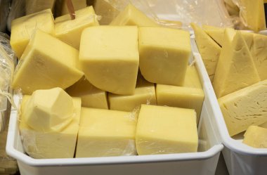 Çedar peynirinin yakın çekimi markette satılır. Üçgen şeklinde dilimler.