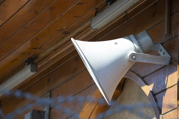 White megaphone hanging on a wood wall — Stock Photo, Image