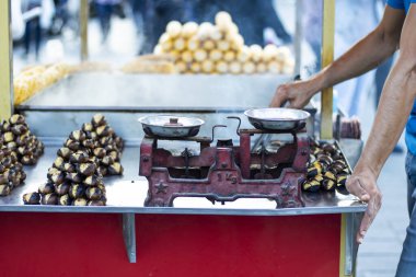 Tekerlekli sandalyede haşlanmış mısır ve ızgarada pişmiş kestane. Fotoğraf: İstanbul, Türkiye.