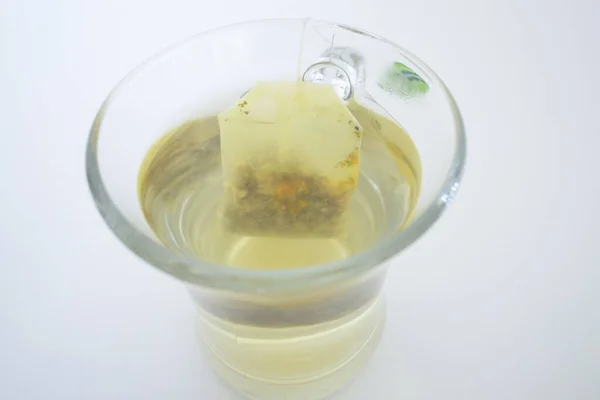 Tea glass cup with tea bag. Tea cup isolated on white background. Close up. — Stock Photo, Image