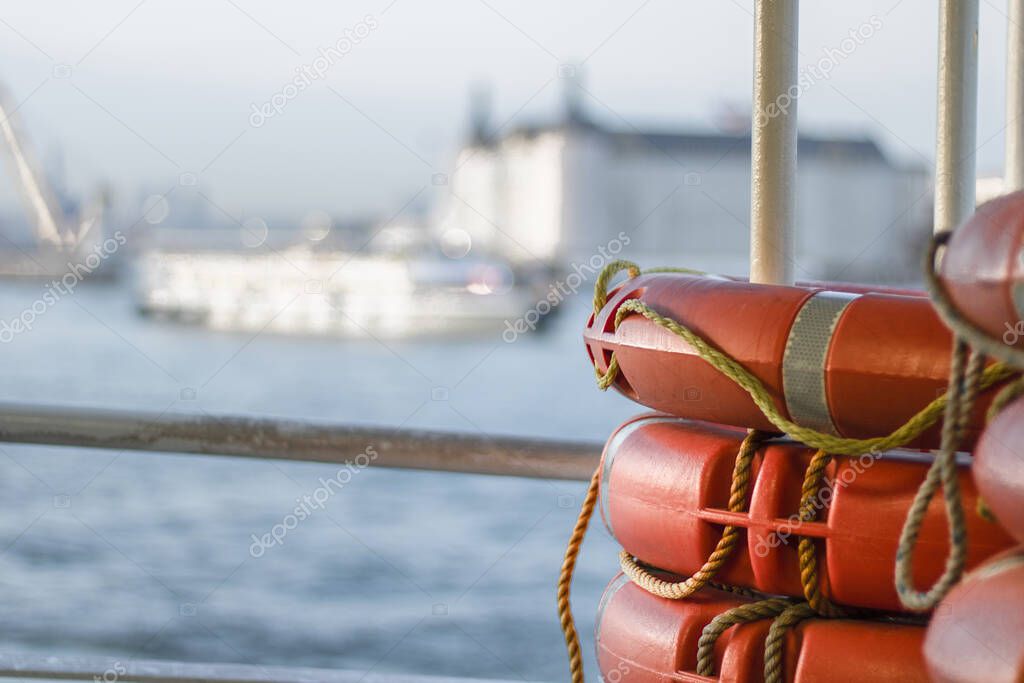 Close up of orange lifebuoy located on the ship. Blurred background. Close up.